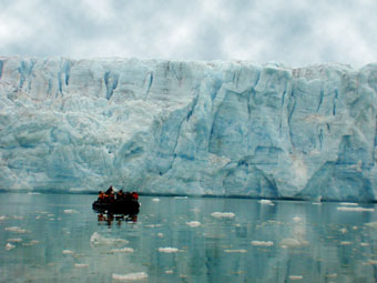 Face of a Svalbard glacier with a boat for scale